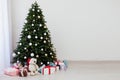 Christmas interior of the white room green Christmas tree with red gifts for the new year decor winter holiday Royalty Free Stock Photo