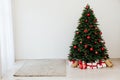 The interior of the white room is a green Christmas tree with red gifts for the new year decor winter holiday Royalty Free Stock Photo