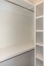 Interior white solid wood closet with wood shelves and a clothing bar Royalty Free Stock Photo