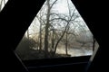 Interior window view from covered bridge on rural river and woods Royalty Free Stock Photo