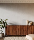 Interior with wood dresser, plants and carpet.