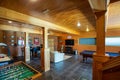 Interior of a wooden game room with a billiard and soccer tables