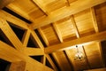 The interior of a wooden house. View of the ceiling with a chandelier