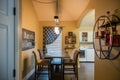 Interiors of a modern kitchen with a table, chairs, signboard, washing machines and kitchenware