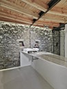interiors shots of a modern bathroom whose floor is made of resin and the ceiling made of wood Royalty Free Stock Photo