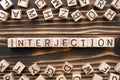 interjection - word from wooden blocks with letters Royalty Free Stock Photo