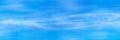 Interlaced white luminous lines on a blue sky background. Royalty Free Stock Photo