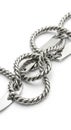 Interlinked metal chains with a twisted rope-like design and circular shapes. The metal appears Royalty Free Stock Photo