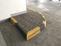 Interlock tile bricks and protected by Concrete kerb stones painted by yellow and black color in an finished vehicle parking