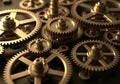 Interlocking brass gears of various sizes, showcasing intricate mechanical design. These gears have Royalty Free Stock Photo