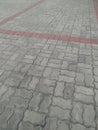 Grey concrete interlocking paver blocks creating abstract textured pattern on ground surface Royalty Free Stock Photo