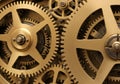 Interlocking gears made of brass, featuring various sizes with evenly spaced teeth. The gears are Royalty Free Stock Photo