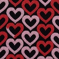 Interlocking heart patterns in red and pink adorn a black background. Each heart is Royalty Free Stock Photo