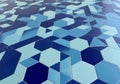 Interlocking hexagonal tiles in shades of blue create an abstract geometric pattern. The tiles vary Royalty Free Stock Photo