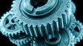 Interlocking metal gears forming a mechanical system under dim lighting Royalty Free Stock Photo