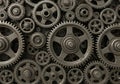 Interlocking metal gears of varying sizes are densely arranged, exhibiting a complex mechanical Royalty Free Stock Photo