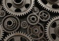 Interlocking metallic gears of various sizes, featuring a series of toothed wheels meshed together. Royalty Free Stock Photo