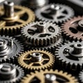 Interlocking metallic gears of varying sizes and colors are closely arranged. They Royalty Free Stock Photo
