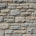 Interlocking pattern of textured stone bricks in shades of gray and beige. The surface Royalty Free Stock Photo
