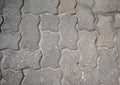 Interlocking paving with gray and white concrete blocks.