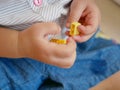 Interlocking plastic bricks toy in baby`s hands