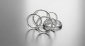 Interlocking Silver Rings on a Reflective Metallic Surface connected Royalty Free Stock Photo