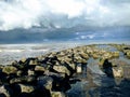 interlocking stones breakwater at low-tide Royalty Free Stock Photo