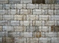 Interlocking wall with gray and brown concrete blocks