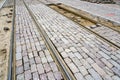 Intermediate tram track surface newly paved with historic cube-shaped granite cobblestones