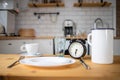 intermittent fasting concept alarm clock on kitchen table Royalty Free Stock Photo