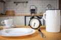 intermittent fasting concept alarm clock on kitchen table Royalty Free Stock Photo