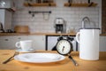 intermittent fasting concept alarm clock on kitchen table Royalty Free Stock Photo