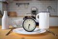 intermittent fasting concept alarm clock on kitchen table Royalty Free Stock Photo