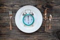 Intermittent Fasting Concept with Clock on Plate Royalty Free Stock Photo