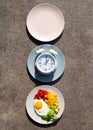 Intermittent fasting concept with empty colorful plates. Time to lose weight , eating control or time to diet concept. Royalty Free Stock Photo