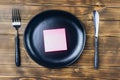 Intermittent fasting concept with empty black plate Royalty Free Stock Photo
