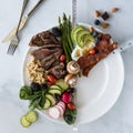 16:8 Intermittent fasting concept. Various Ketogenic diet foods arranged to convey condensed feeding window. Royalty Free Stock Photo