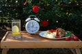 Intermittent fasting diet and Concept for healthy eating and nutrition. Alarm clock and diet food ingredients on wooden