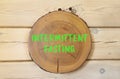 Intermittent fasting symbol. Concept words Intermittent fasting on beautiful wooden circle. Beautiful wooden wall background. Royalty Free Stock Photo