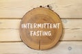 Intermittent fasting symbol. Concept words Intermittent fasting on beautiful wooden circle. Beautiful wooden wall background. Royalty Free Stock Photo