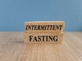 Intermittent fasting symbol. Concept words Intermittent fasting on brick blocks. Beautiful wooden table, blue background. Healthy Royalty Free Stock Photo