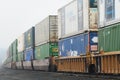 Intermodal container train passing in the mist Royalty Free Stock Photo