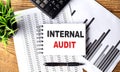 INTERNAL AUDIT text on a notebook with chart and calculator