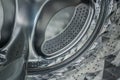 Internal closeup view of washer stainless steel drum.