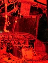 Internal cockpit of disused abandoned Helicopter grounded at night with red lighting to show controls wiring and