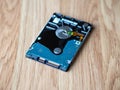 Internal laptop hard disk drive HDD placed on a wooden surface Royalty Free Stock Photo
