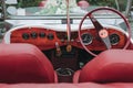 Internal part of a retro Mercedes Benz car in shades of red.