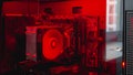 Internal parts of the computer system unit: cooler, hard disk, motherboard, video card in red backlight