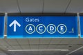 International Airport sign Gates A C D E in interior air terminal Royalty Free Stock Photo
