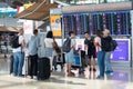 International Airport Suvarnabhumi people look at flight schedule screen, passengers near information display board